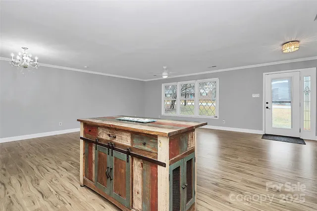 a kitchen that has a stove and a wooden floor