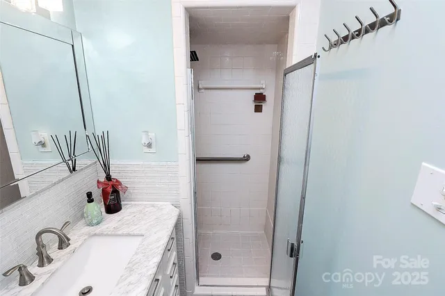 a bathroom with a tub sink and mirror