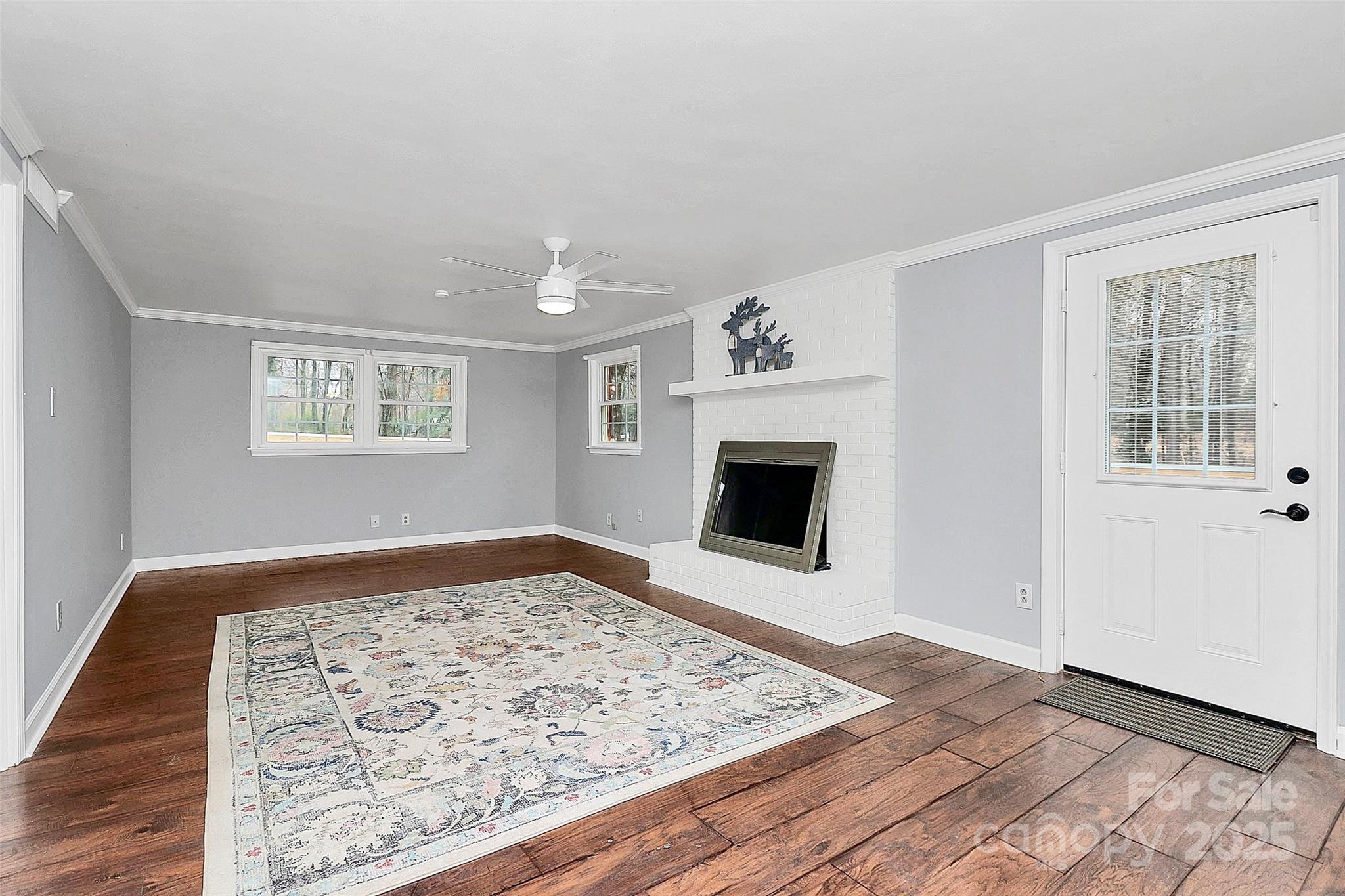710 Plantation Road Lancaster, SC 29720 - Photo 24 of 29 a view of a livingroom with wooden floor and a fireplace
