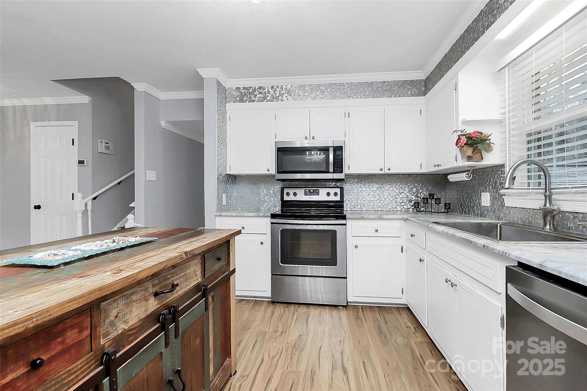 710 Plantation Road Lancaster, SC 29720 - Photo 9 of 29 a kitchen with granite countertop a stove sink and refrigerator