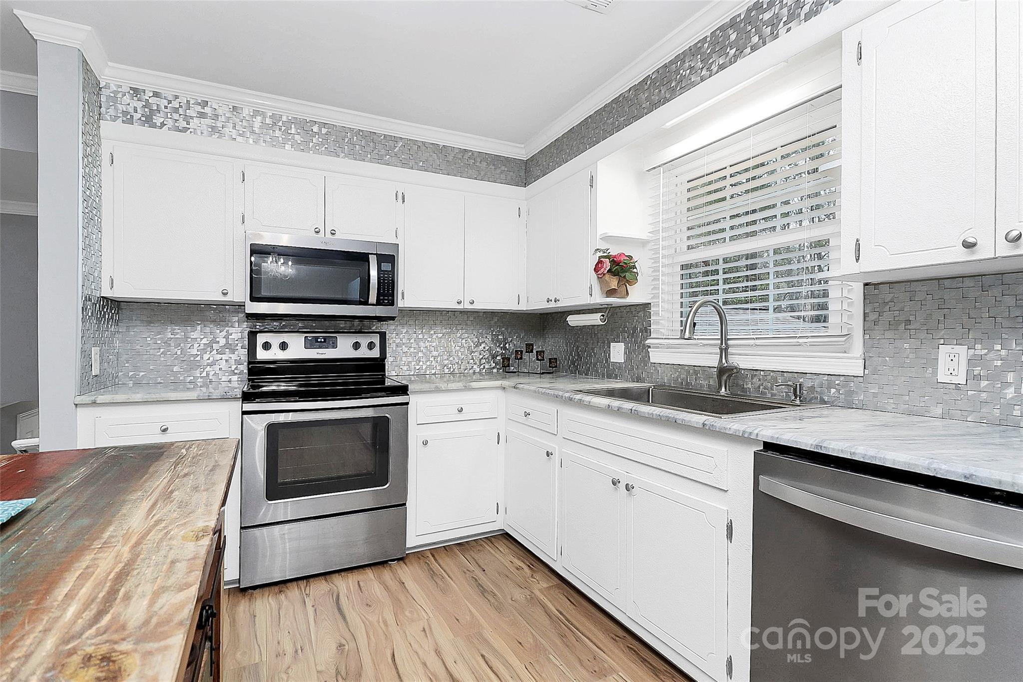 710 Plantation Road Lancaster, SC 29720 - Photo 10 of 29 a kitchen with stainless steel appliances white cabinets a sink and a stove