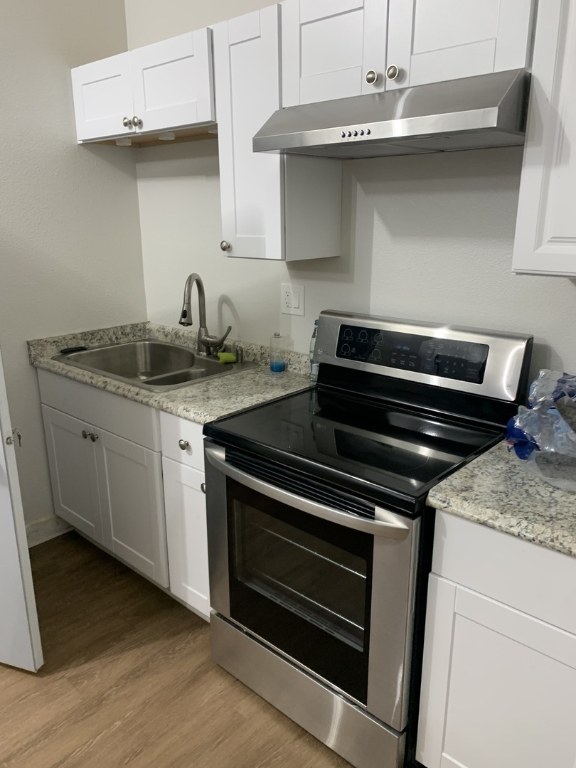 813 North Menge Road Marengo, IL 60152 - Photo 28 of 34 a kitchen with granite countertop a stove and a sink