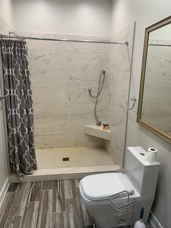 a bathroom with a toilet and a shower