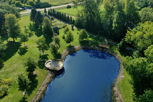 an aerial view of a house with a yard and garden