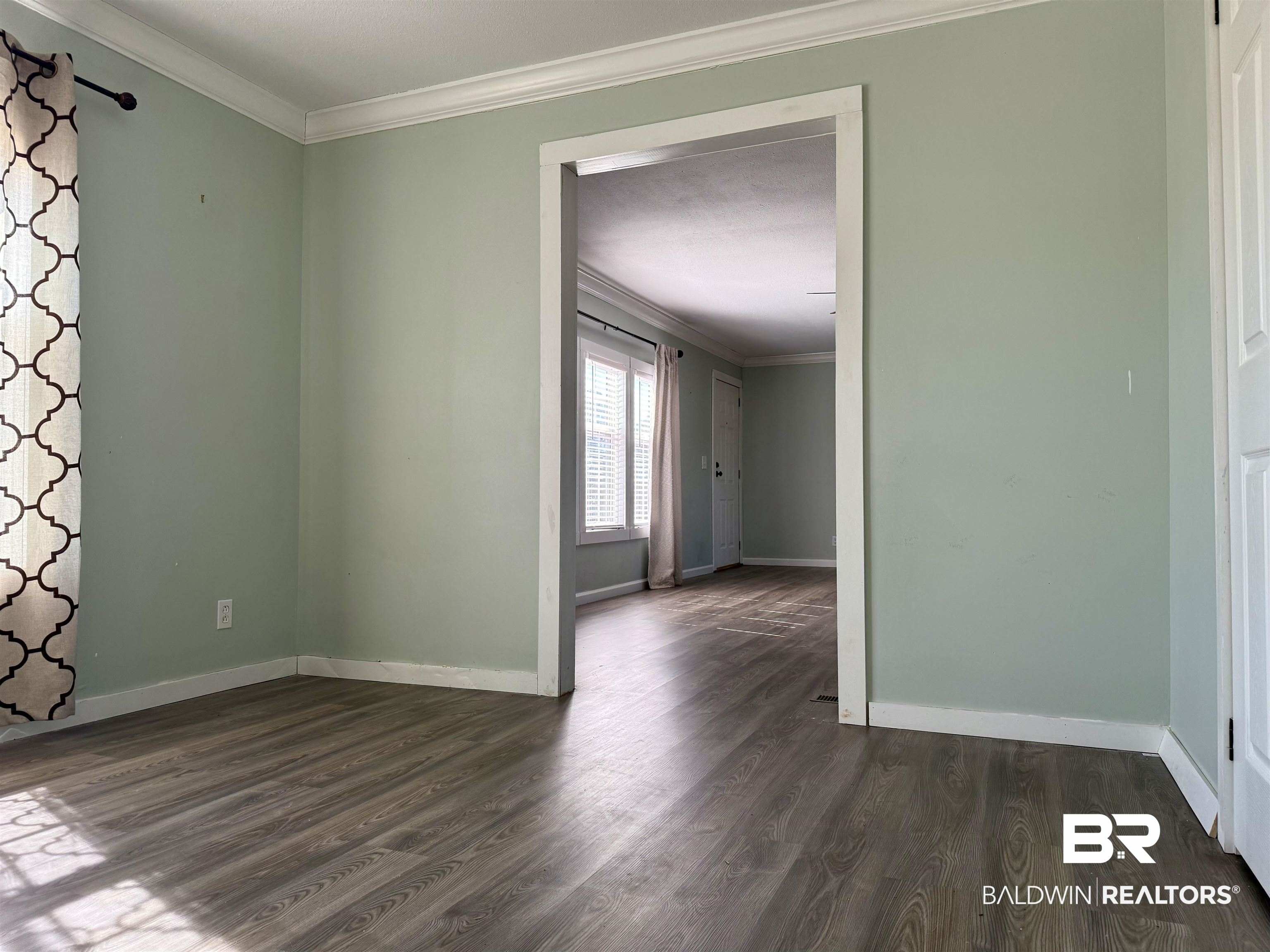 1064 Old Fannie Road Flomaton, AL 36441 - Photo 9 of 17 Unfurnished room with crown molding and dark wood-style flooring