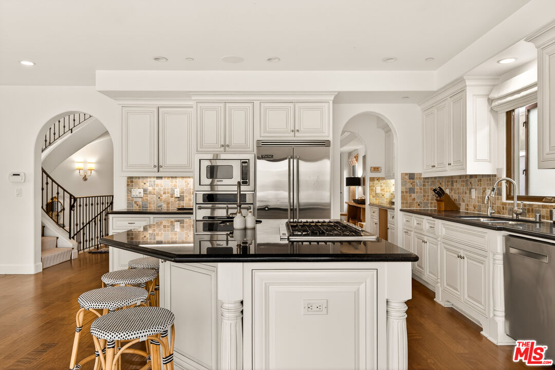 17 Privateer Street Marina del Rey, CA 90292 - Photo 21 of 47 a kitchen with kitchen island granite countertop a sink cabinets and wooden floor