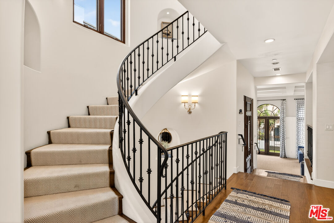 17 Privateer Street Marina del Rey, CA 90292 - Photo 26 of 47 a view of staircase with lots of frames on wall and a dining table
