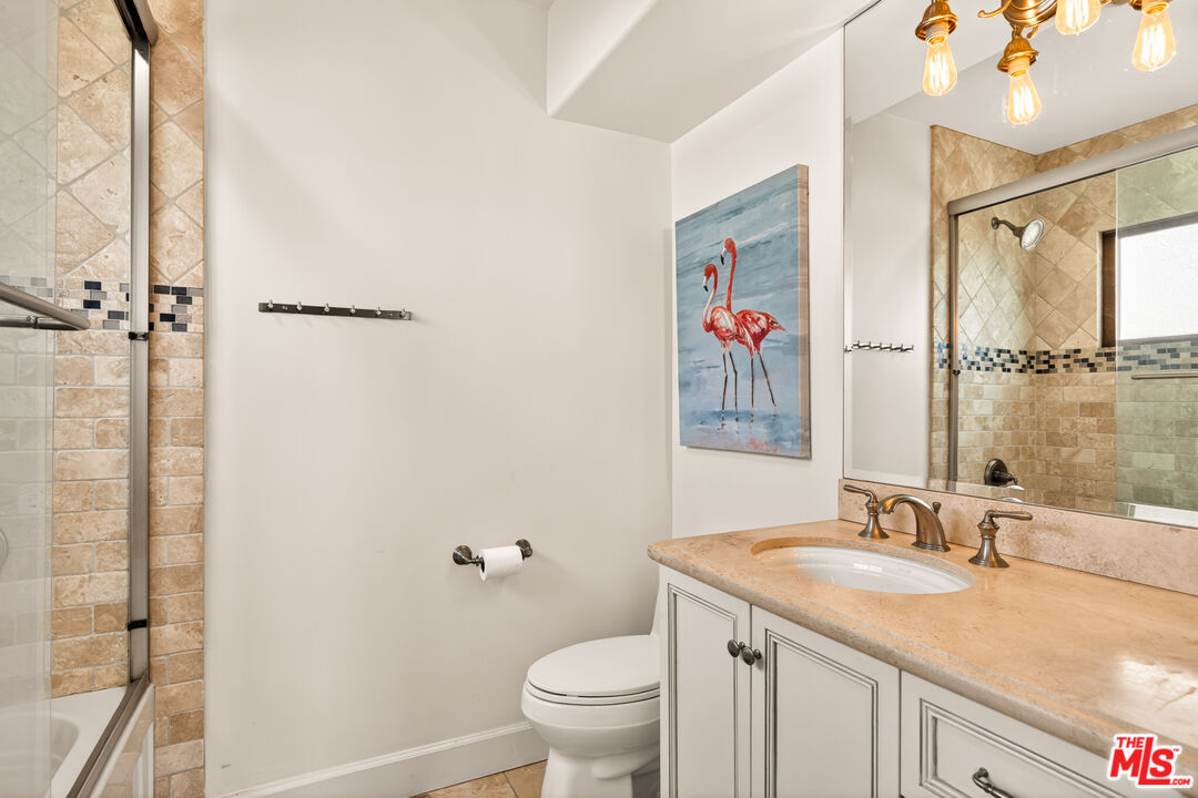 17 Privateer Street Marina del Rey, CA 90292 - Photo 36 of 47 a bathroom with a granite countertop sink a toilet and a mirror