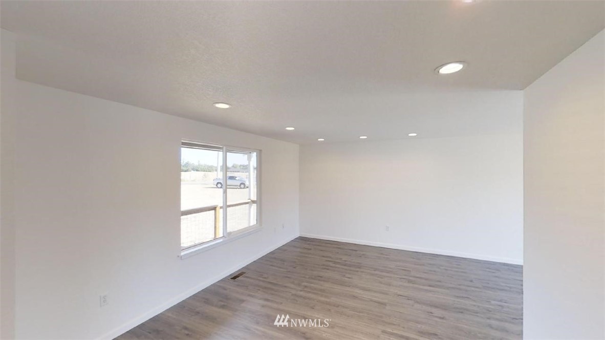 17849 Danby Drive Southwest Rochester, WA 98579 - Photo 14 of 23 an empty room with wooden floor and windows