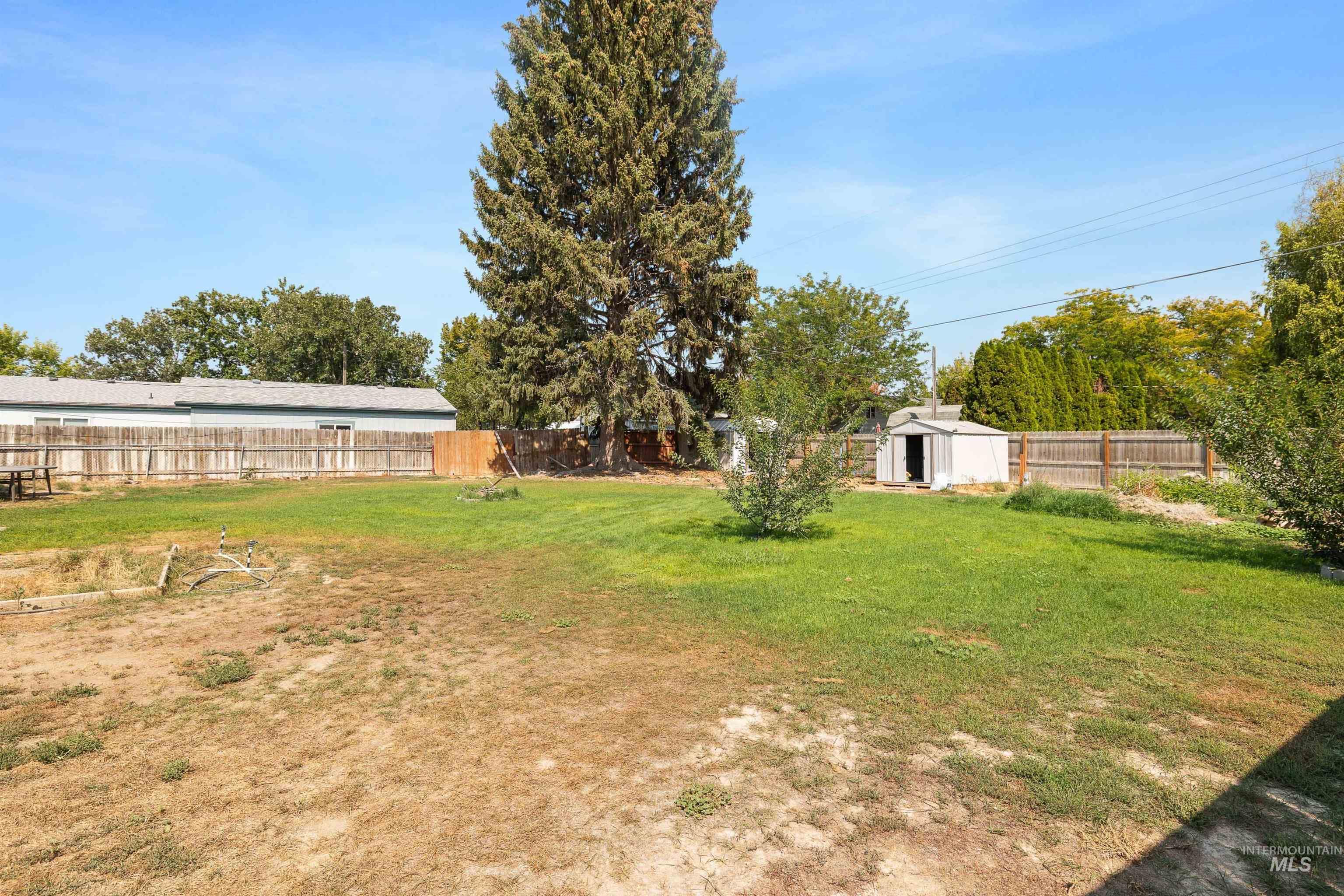 817 Union Avenue Filer, ID 83328 - Photo 24 of 37 Fenced backyard with a storage unit