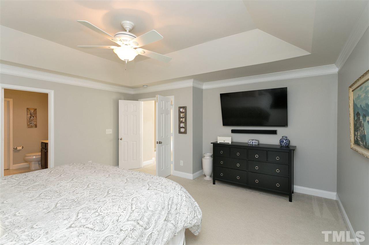 167 Solheim Lane Raleigh, NC 27603 - Photo 11 of 25 a bedroom with a bed and a flat screen tv