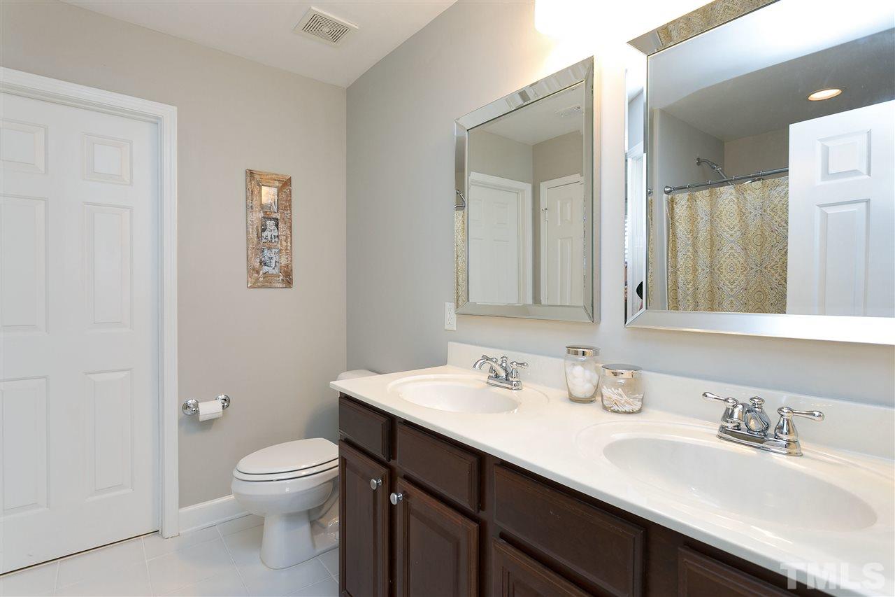 167 Solheim Lane Raleigh, NC 27603 - Photo 12 of 25 a bathroom with a sink a toilet and a mirror