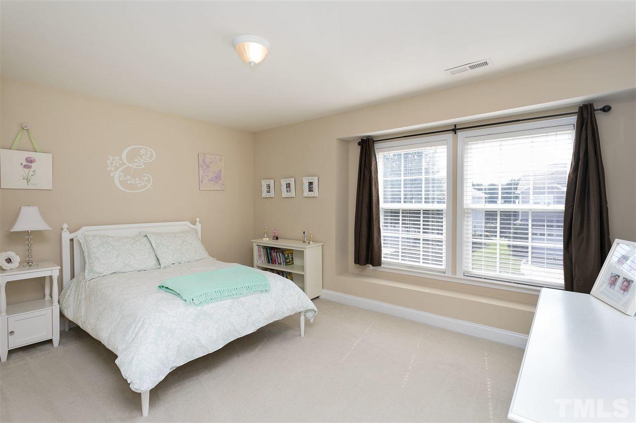 167 Solheim Lane Raleigh, NC 27603 - Photo 14 of 25 a bedroom with a large bed and a large window