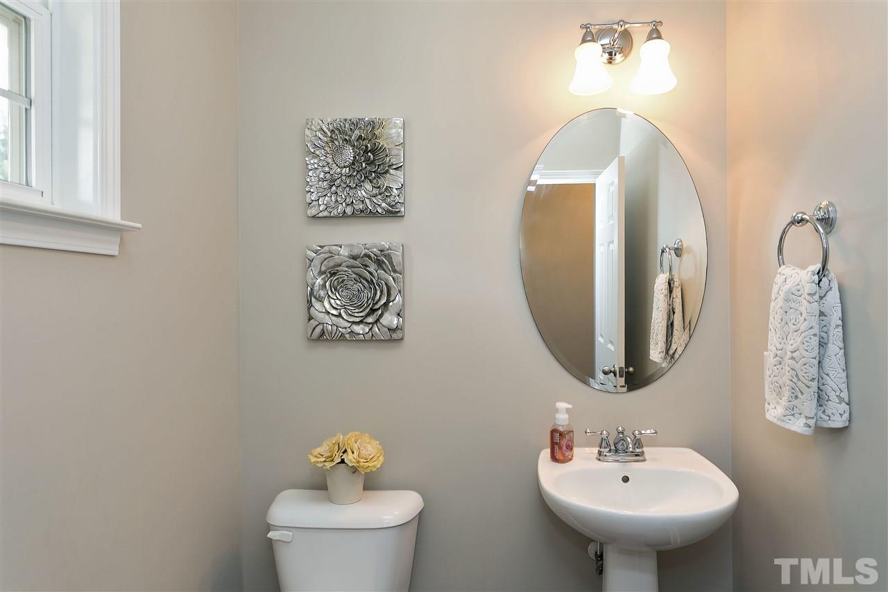 167 Solheim Lane Raleigh, NC 27603 - Photo 21 of 25 a bathroom with a toilet sink and mirror