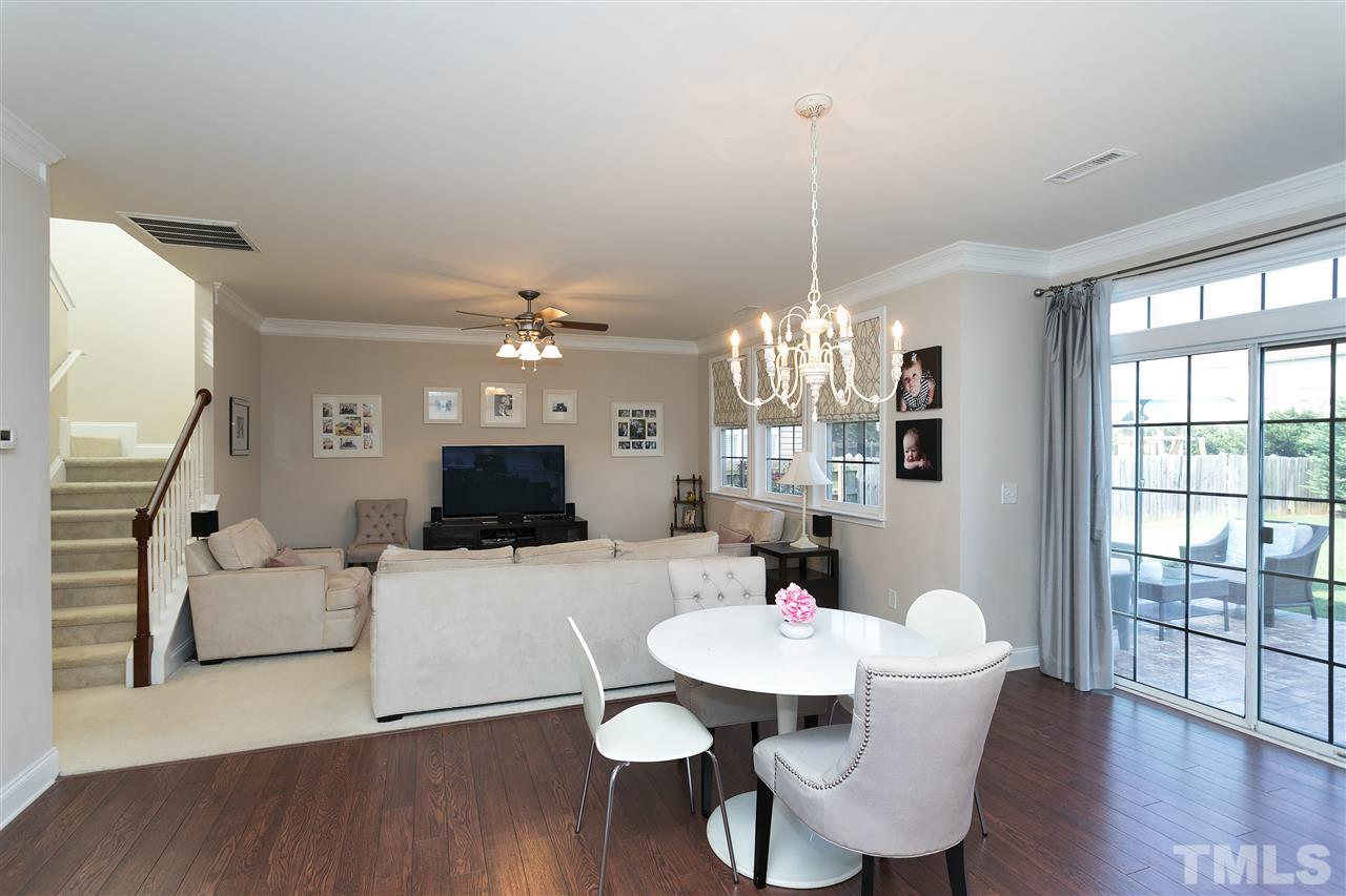 167 Solheim Lane Raleigh, NC 27603 - Photo 6 of 25 a view of a dining room with furniture wooden floor and chandelier