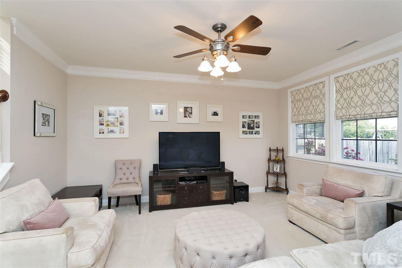 167 Solheim Lane Raleigh, NC 27603 - Photo 8 of 25 a living room with furniture a large window and a flat screen tv