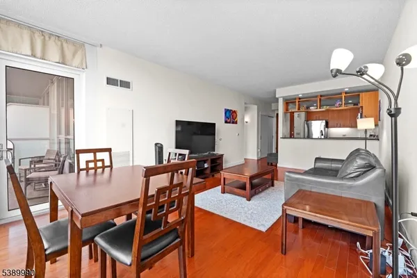 a view of a livingroom with furniture and a flat screen tv
