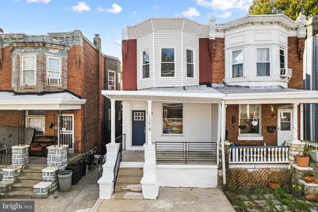 a front view of a building with a porch