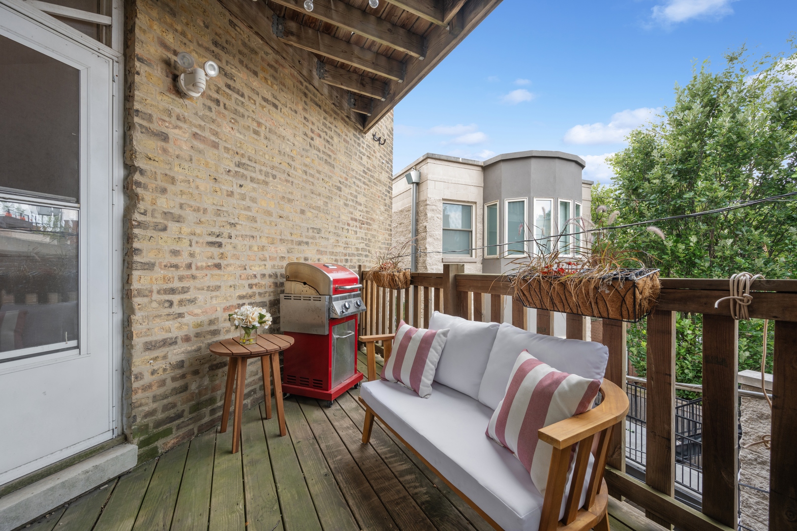 1667 North Bissell Street, Unit 2 Chicago, IL 60614 - Photo 13 of 14 a view of a deck with couches table and chairs and wooden floor