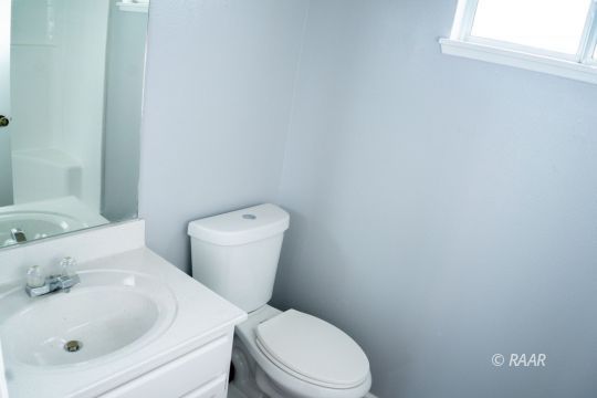 148 South Lilac Street Ridgecrest, CA 93555 - Photo 26 of 34 a white toilet sitting next to a bathroom sink