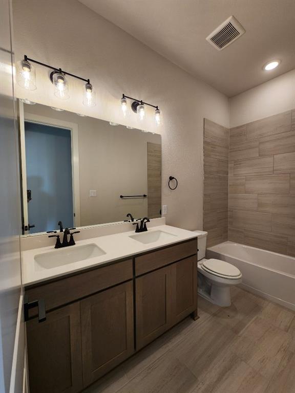 2305 Gypsum Street Krum, TX 76249 - Photo 20 of 22 Bathroom featuring a double vanity with white countertops, dual undermount sinks, and matte black fixtures
