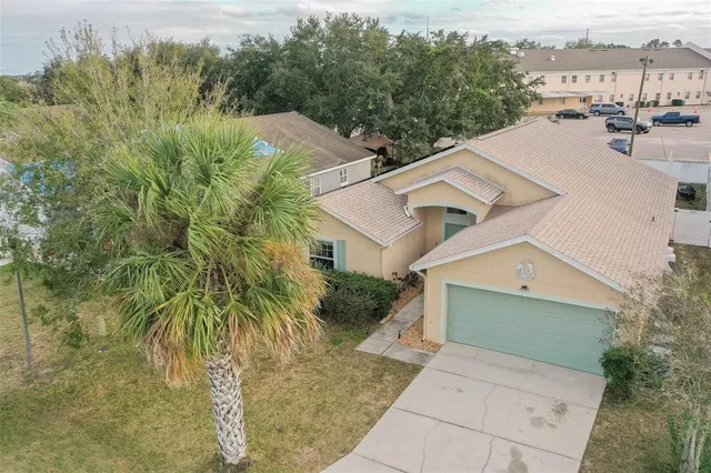 an aerial view of a house with a yard