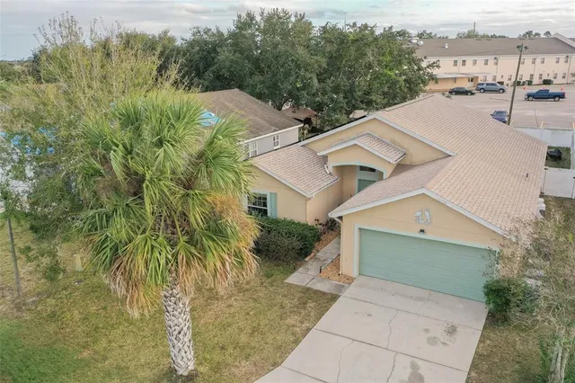a aerial view of a house with a yard
