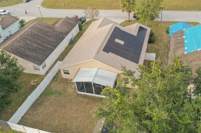 an aerial view of a house with outdoor space