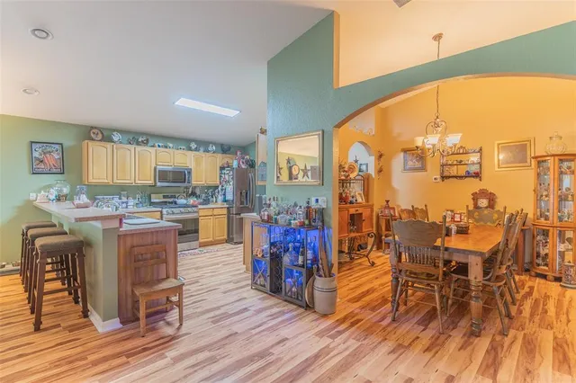 a open kitchen with granite countertop lots of counter top space and painting on the wall