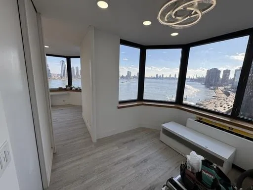 a kitchen that has a sink a stove and wooden floor