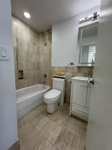 a view of room with window and wooden floor