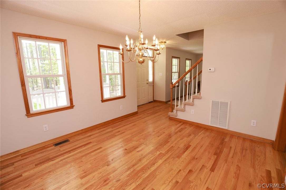 7100 Hair Road Disputanta, VA 23842 - Photo 15 of 40 a view of empty room with wooden floor and fan