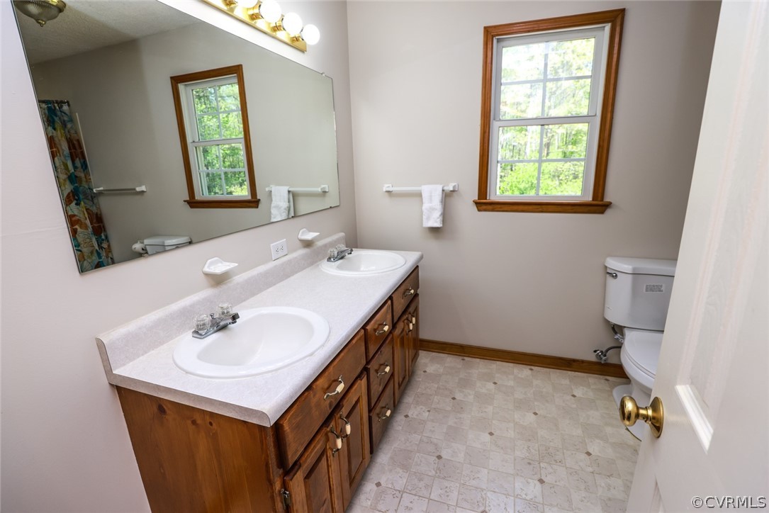 7100 Hair Road Disputanta, VA 23842 - Photo 19 of 40 a bathroom with a sink toilet and mirror