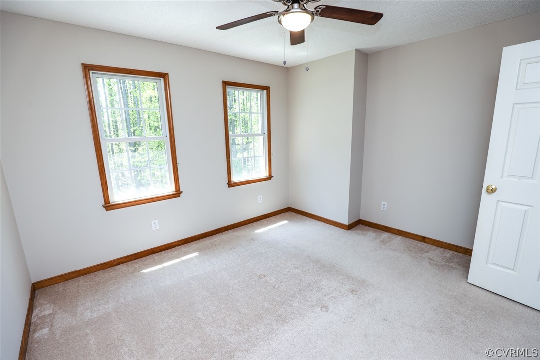 7100 Hair Road Disputanta, VA 23842 - Photo 23 of 40 an empty room with windows and fan