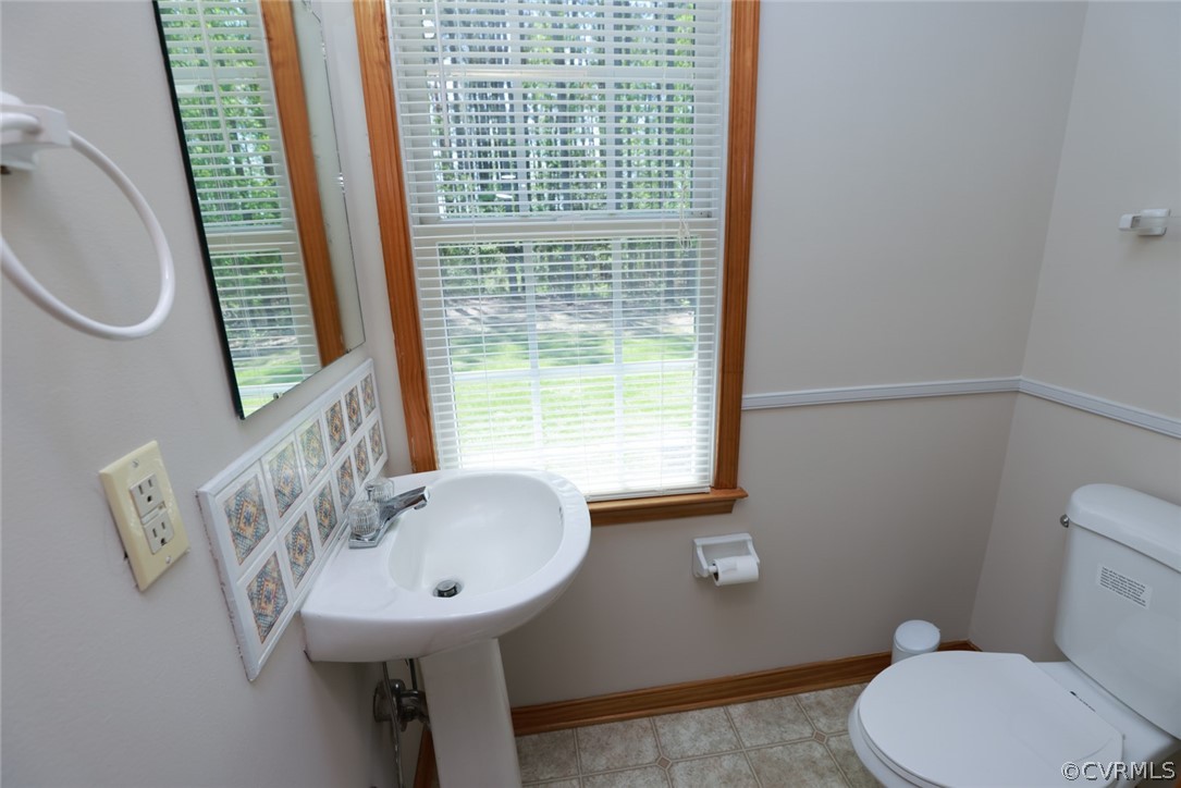 7100 Hair Road Disputanta, VA 23842 - Photo 26 of 40 a bathroom with a sink a toilet and a mirror