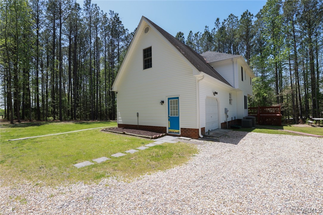 7100 Hair Road Disputanta, VA 23842 - Photo 29 of 40 a view of a white house with a yard and trees