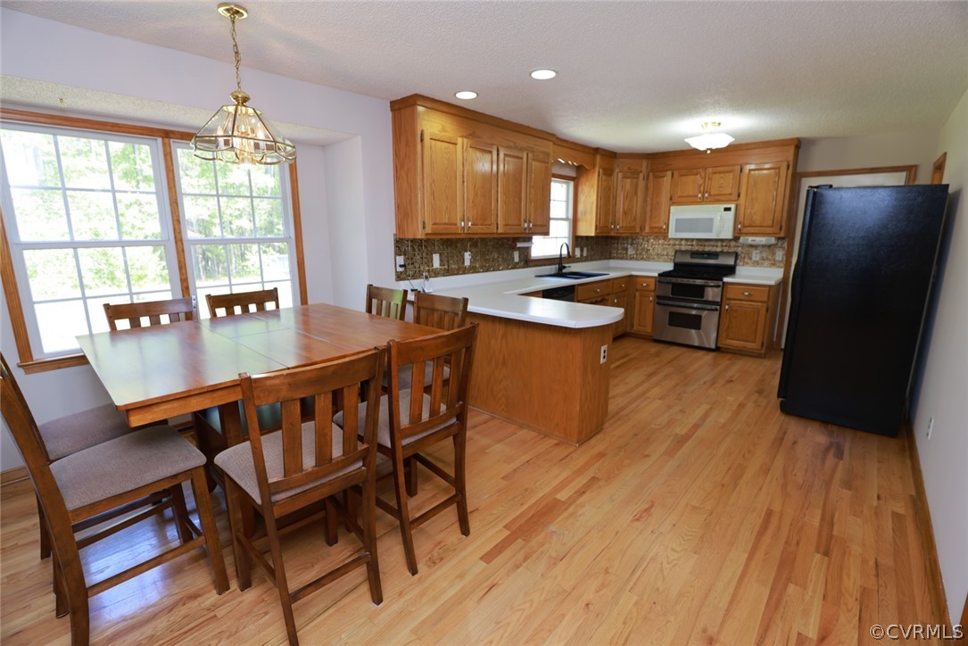 7100 Hair Road Disputanta, VA 23842 - Photo 7 of 40 a kitchen with a table chairs refrigerator and window