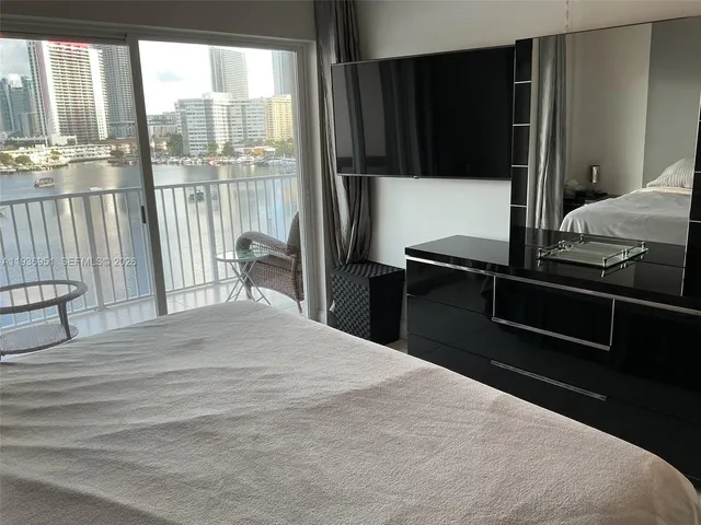 a bedroom with a bed and large window