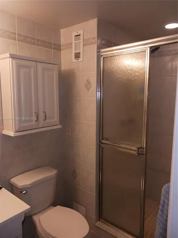a bathroom with a toilet and a shower