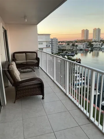 a balcony with a bench and city view