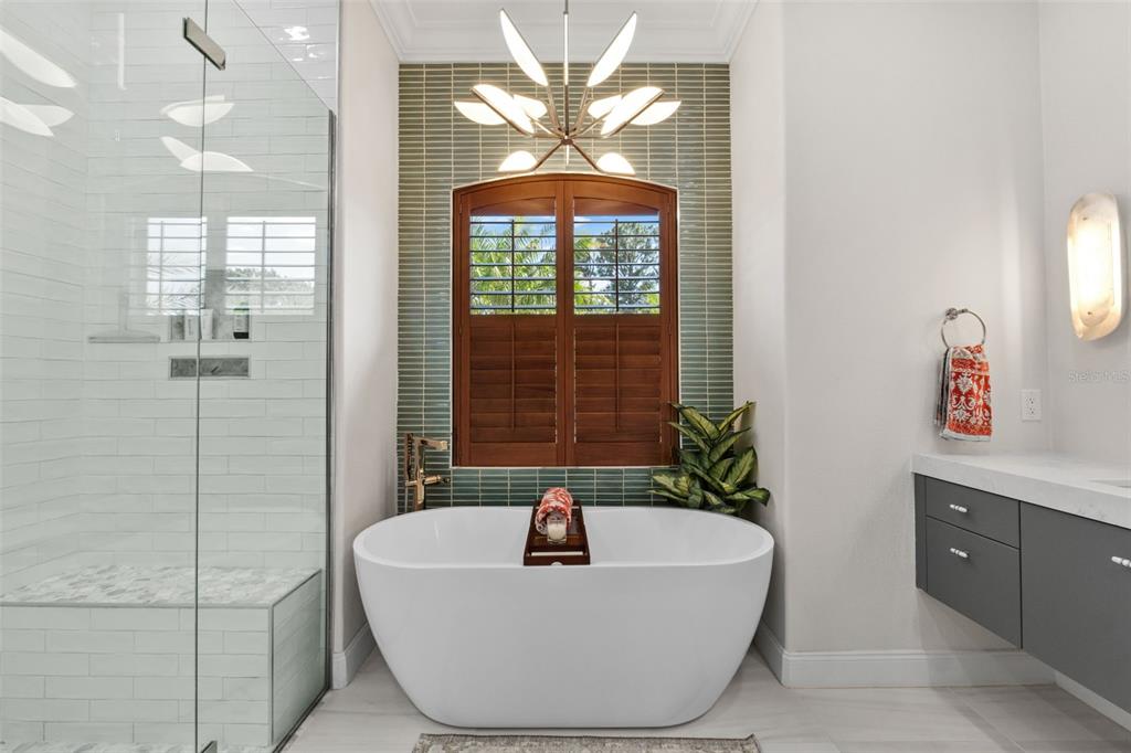 13137 Lake Butler Boulevard Windermere, FL 34786 - Photo 14 of 98 a white bath tub sitting in a bathroom next to a window