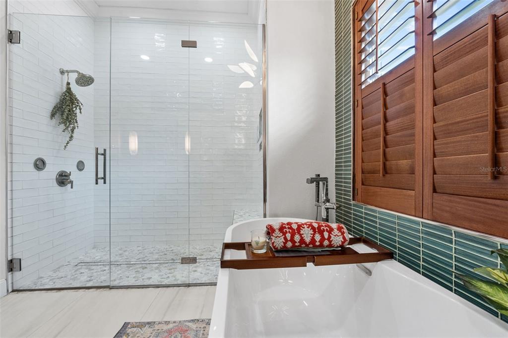 13137 Lake Butler Boulevard Windermere, FL 34786 - Photo 18 of 98 a bathroom with a granite countertop shower a sink and a mirror