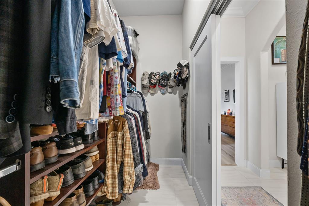 13137 Lake Butler Boulevard Windermere, FL 34786 - Photo 26 of 98 a view of walk in closet with clothes and shoes