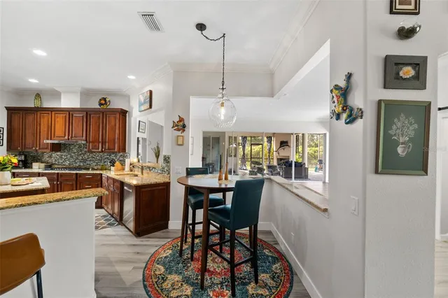 a living room with furniture large window and wooden floor