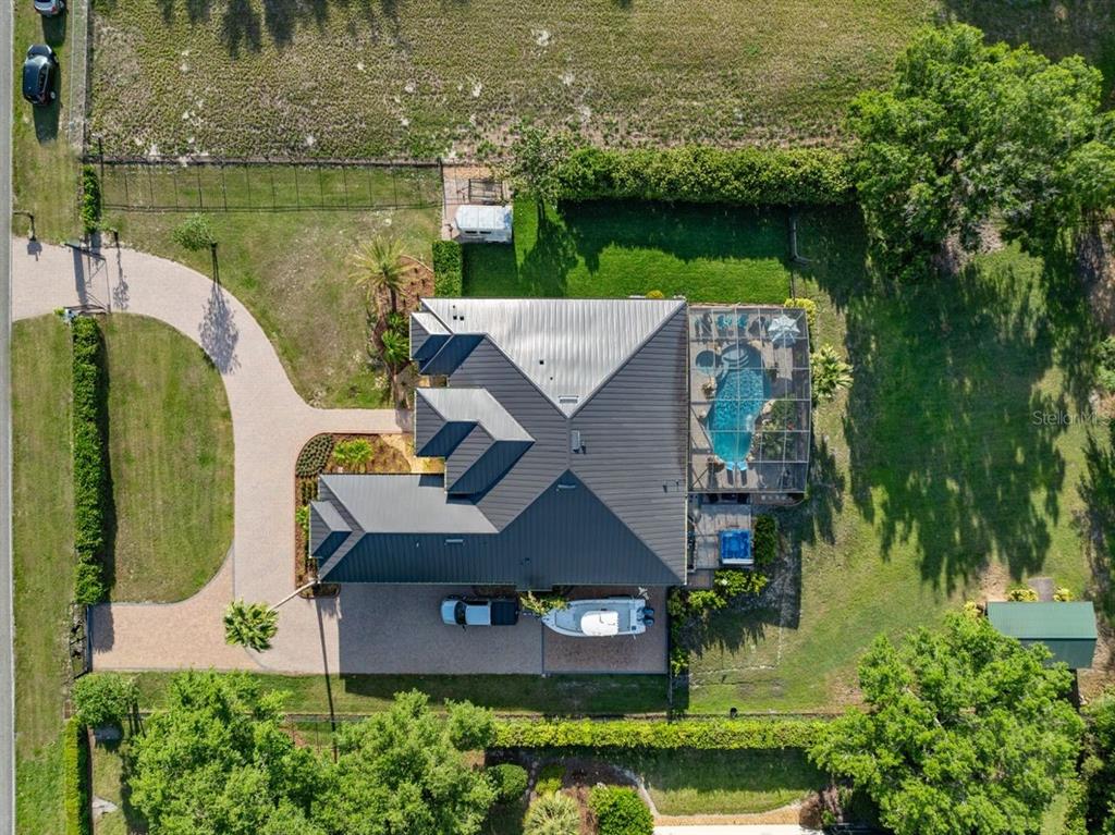 13137 Lake Butler Boulevard Windermere, FL 34786 - Photo 78 of 98 an aerial view of a house with a garden and lake view