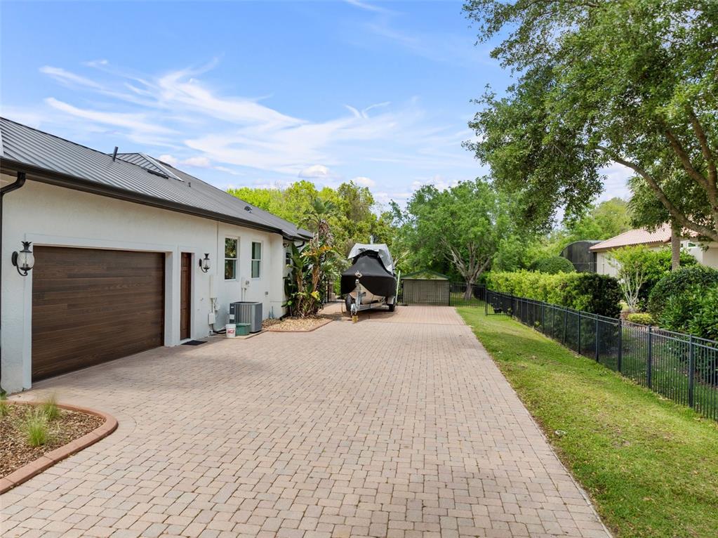 13137 Lake Butler Boulevard Windermere, FL 34786 - Photo 81 of 98 a front view of a house with a yard and garage