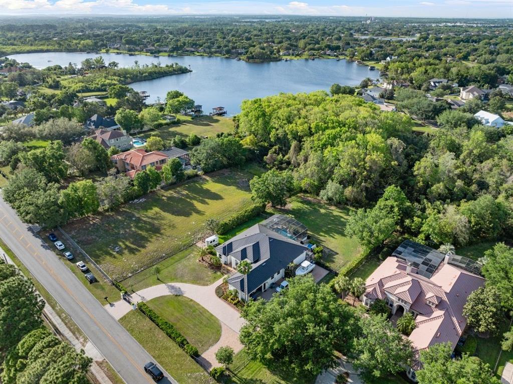 13137 Lake Butler Boulevard Windermere, FL 34786 - Photo 84 of 98 an aerial view of residential houses with outdoor space and river