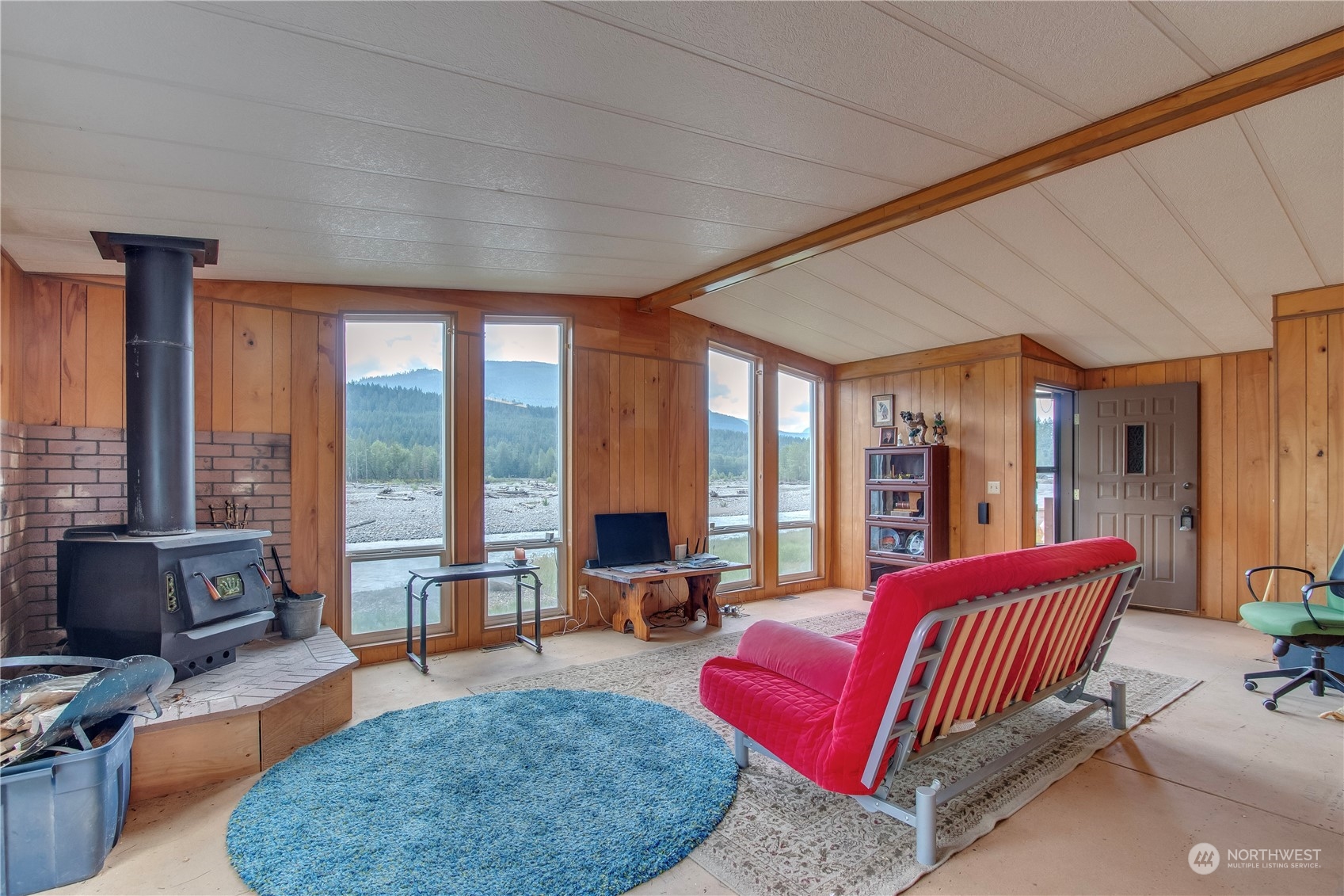 140 Maple Place Packwood, WA 98361 - Photo 13 of 39 a living room with furniture and floor to ceiling windows