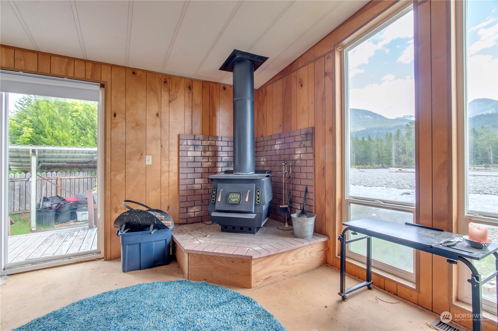 140 Maple Place Packwood, WA 98361 - Photo 15 of 39 a living room with furniture and a floor to ceiling window