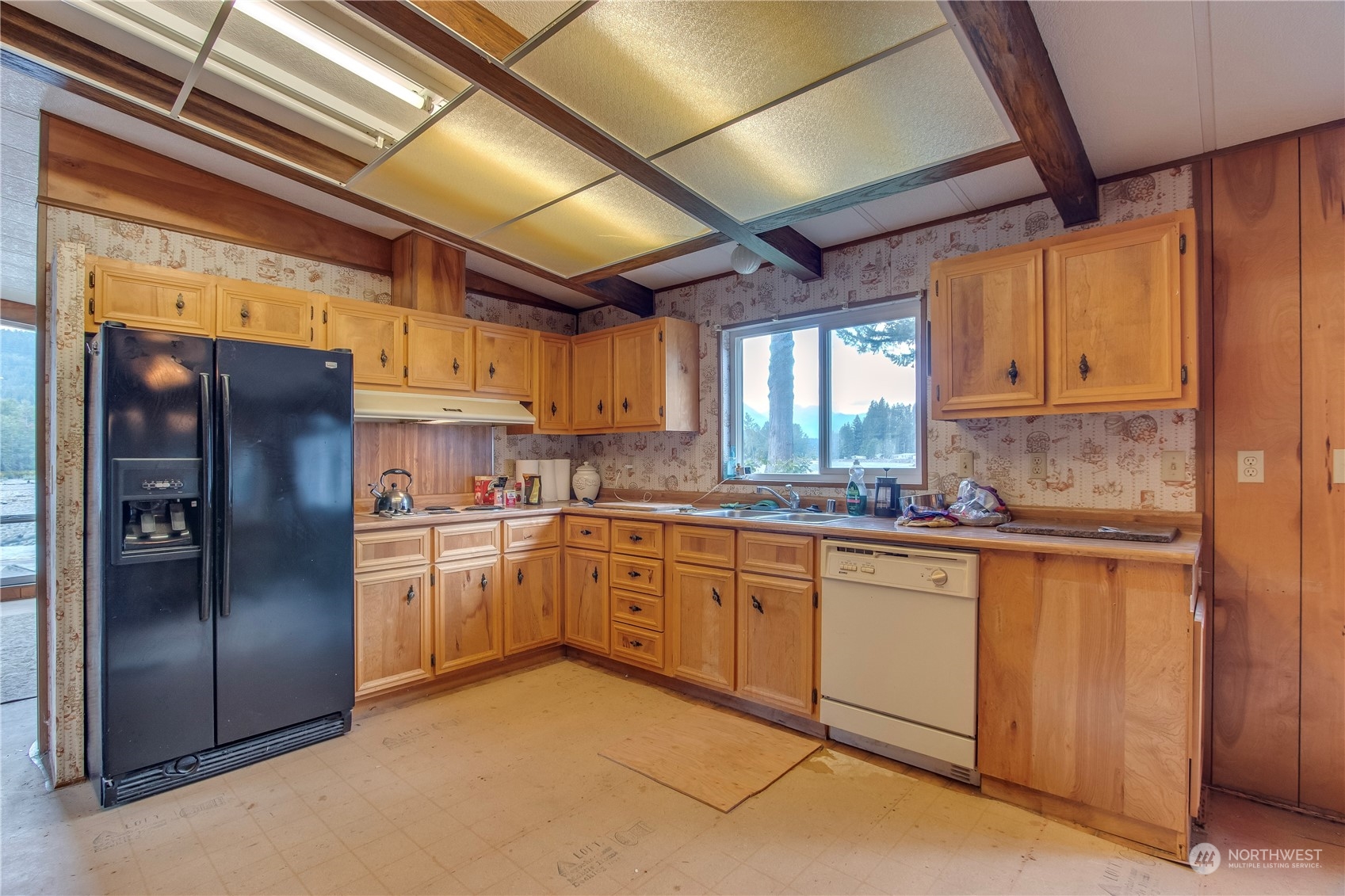 140 Maple Place Packwood, WA 98361 - Photo 19 of 39 a kitchen with stainless steel appliances granite countertop a refrigerator a sink a stove and white cabinets
